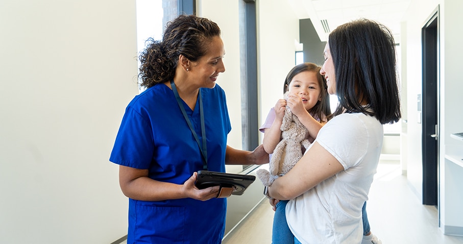 Female medical professional with mother and daughter